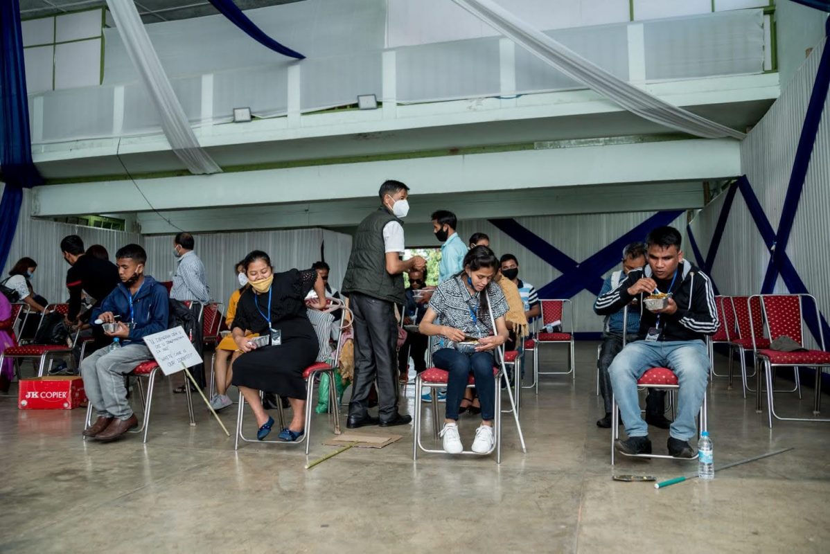 blind people sitting together and having food