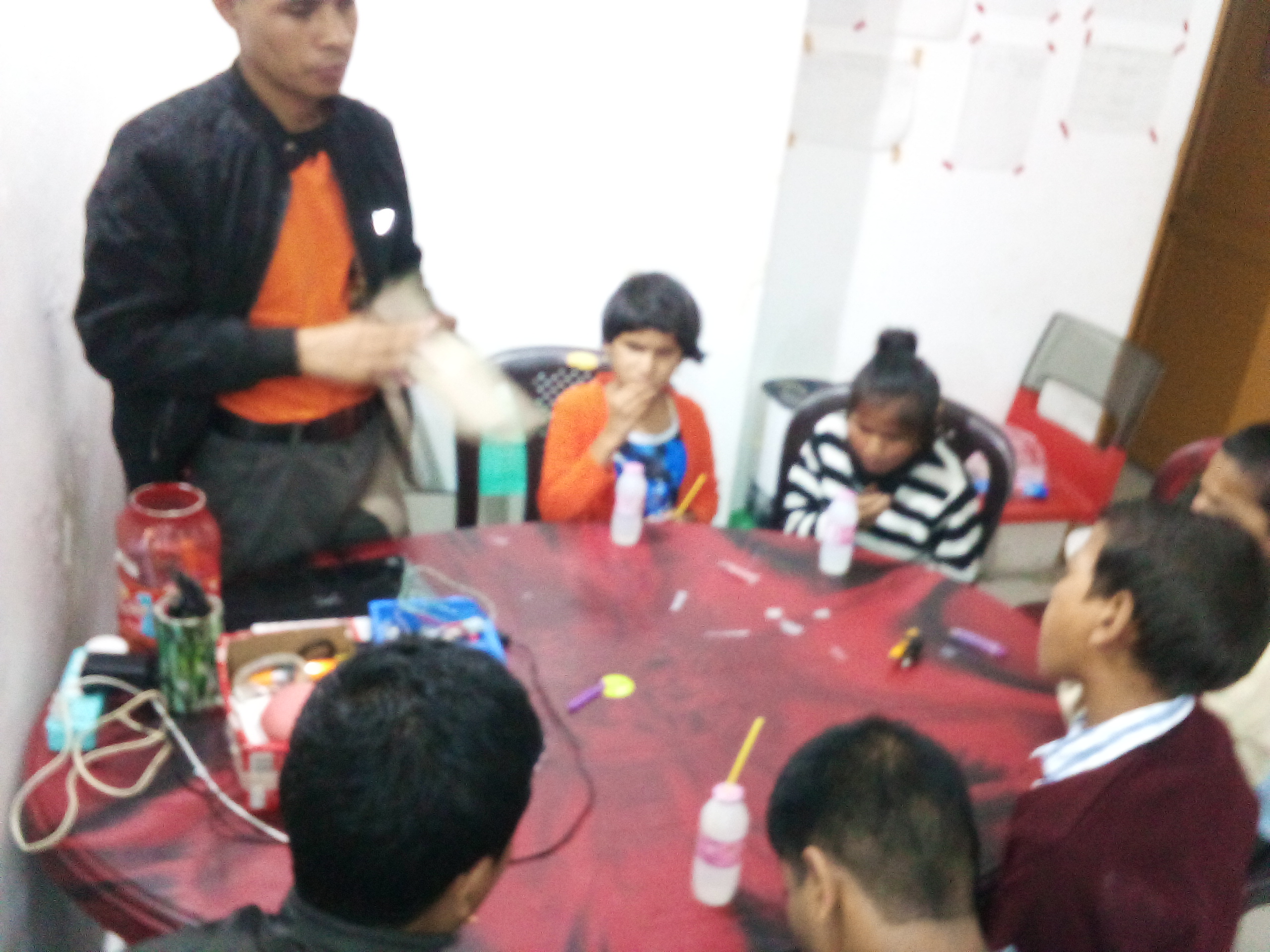Photo: children sitting around a table  and having snacks - 1