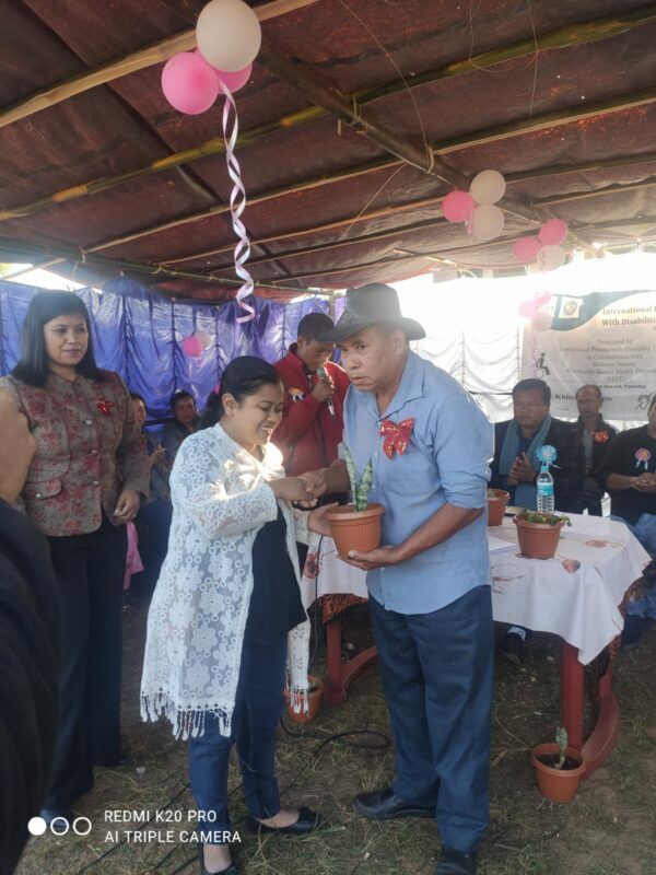 Photo: Ms. Bandwina Khymdeit (Assistant Membership) presented the Bouquet to the Headman of Khlieh Umtrew Village