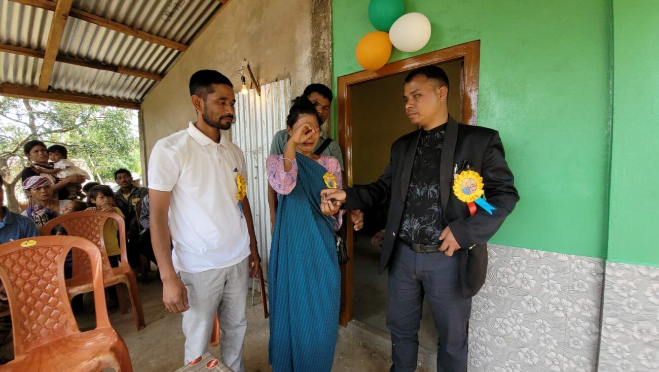 photo"Shri.Jitendra dkhar along with MDC shri.Dawan Lyngdoh present the key of the house to Kong Mary Kyndait. Kong mary Burst into tears after receiving the house keys.